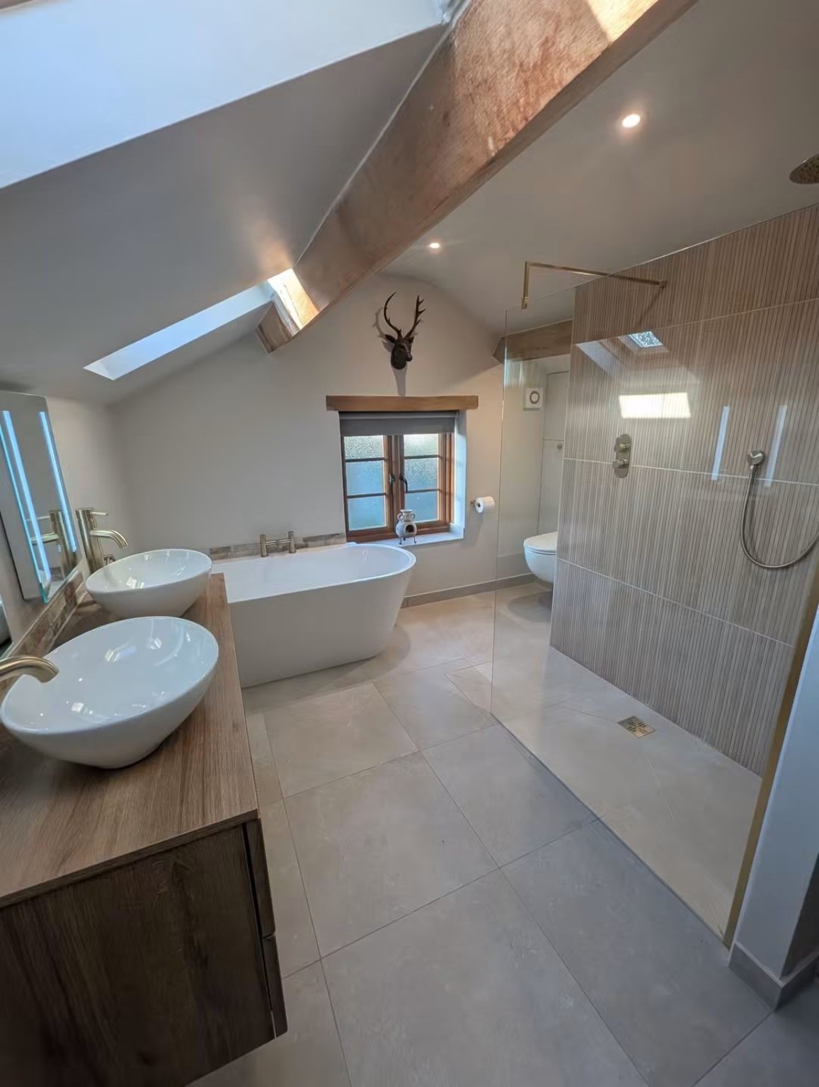 Completed vaulted bathroom renovation with exposed timber beam
